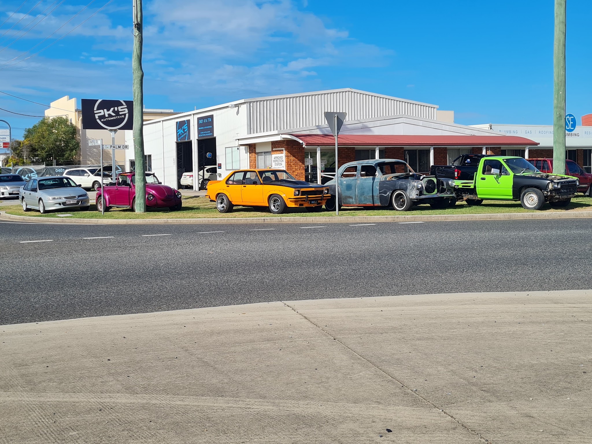 The Chapple Street workshop with customer classic cars lined up out the front